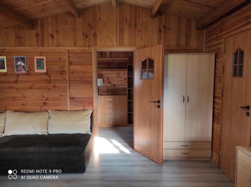 a bedroom with a bed and a closet in a room at Domki letniskowe "DORCIA" in Łeba