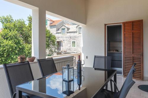 a balcony with a glass table and chairs on a patio at Center apartment Golden Ray in Bol