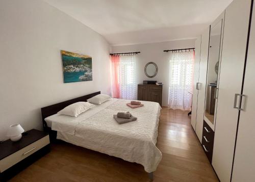 a bedroom with a bed with two towels on it at Apartment Moris in Vodnjan