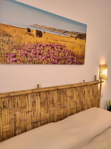 a painting of a field of flowers on a wall at B&B San Vito in Tricase