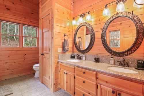a bathroom with two sinks and two mirrors at Relaxing Cabin near Bear Claw Vineyard, Hot Tub, Game Room, Pet Friendly, sleeps10 in Blue Ridge