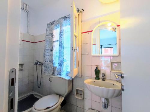 a bathroom with a toilet and a sink and a shower at Relax like the Old Days in Kastanéa