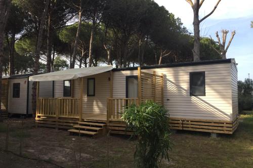 a mobile home with a porch and a deck at Mobile Home OuiReves 113 facing the Mediterranean in Sète