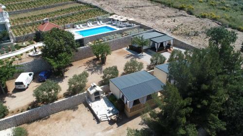 an aerial view of a house with a swimming pool at New Adria mobile Home - camp Vala in Orebić