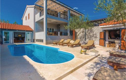 a swimming pool in the backyard of a house at Lovely Home In Pridraga With House Sea View in Pridraga