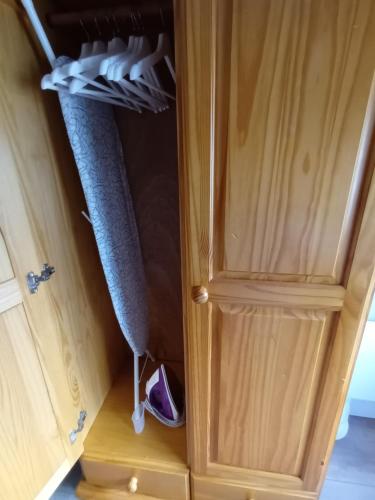 a cupboard with a bed and shoes in it at Parkhill House Self Catering in Ballyshannon