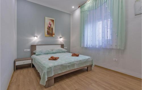 a bedroom with a bed with two brown shoes on it at Gorgeous Home In Pula With Wifi in Pula