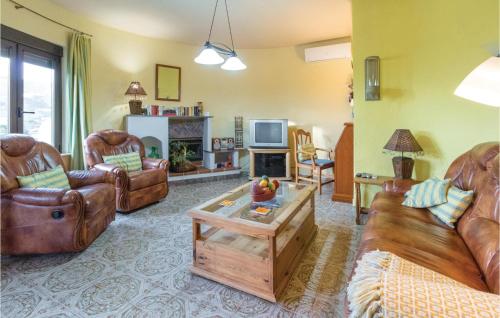a living room with leather couches and a tv at 3 Bedroom Beautiful Home In Almuñecar in Almuñécar