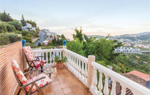 a balcony with chairs and a view of a city at 3 Bedroom Beautiful Home In Almuñecar in Almuñécar