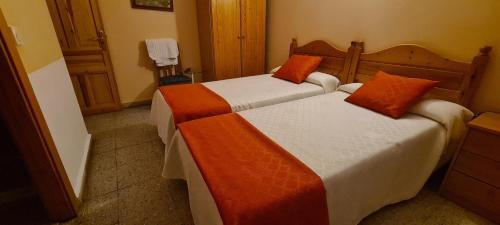A bed or beds in a room at Hostal de la Playa