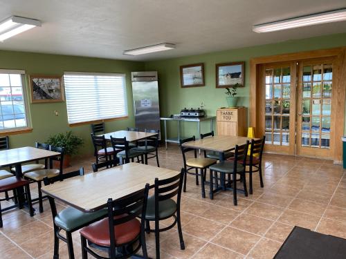 a dining room with wooden tables and chairs at Americas Best Value Inn Kadoka in Kadoka