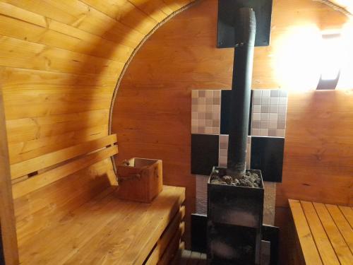 a woodburning stove in a room with wooden floors at Cabanas Chosco Alto in Pucón