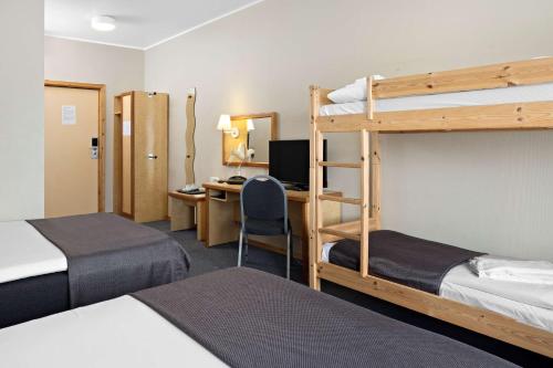 a room with two bunk beds and a desk at Stav Hotel in Malvik