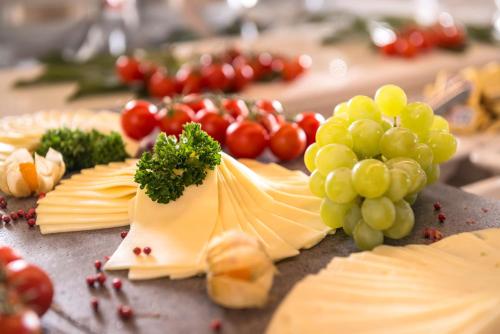 a bunch of cheese and grapes on a table at Dorint Hotel Frankfurt/Oberursel in Oberursel