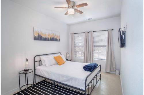 a bedroom with a bed and a ceiling fan at BRAND NEW 2 Stylish 3BR Near Exciting Downtown in San Antonio