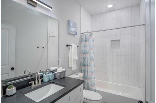 a white bathroom with a sink and a toilet at BRAND NEW 2 Stylish 3BR Near Exciting Downtown in San Antonio