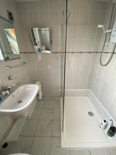 a bathroom with a shower and a sink at Dunfermline, 2 bedroom home free on street parking in Fife