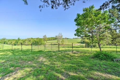 a fence in a field with a tree at Relaxing Rural Harrison Home - 11 Mi to Town in Harrison