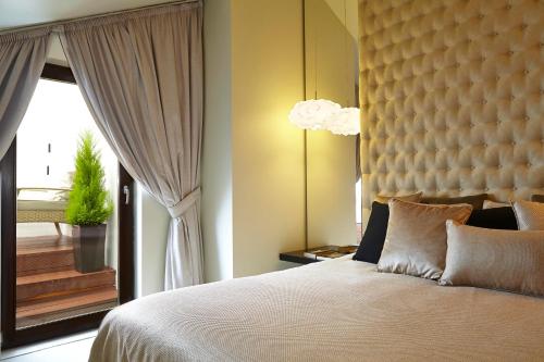 a bedroom with a large bed and a window at 9Hotel Mercy in Lisbon