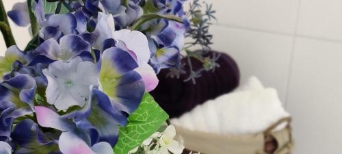 a vase filled with blue and white flowers next to at 'Neasa' Luxury Double Bedroom in Foxford