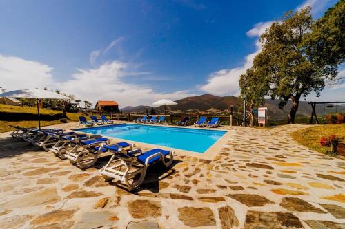 a swimming pool with lounge chairs next to a resort at Arrabia Bunga Douro in Raiva