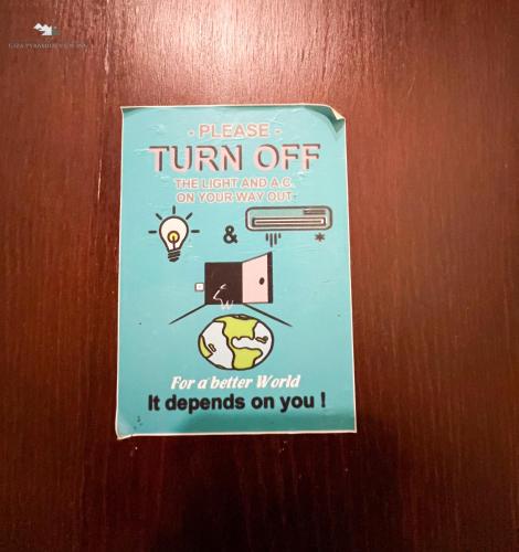 a sign on a door that reads please turn off the light and as do your at Giza Pyramids View Inn in Cairo