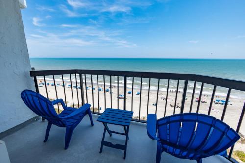 two chairs and a table on a balcony with the beach at Grande Beach Resort in Myrtle Beach