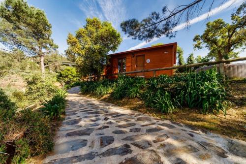 a house with a pathway leading to a building at Arrabia Bunga Payva in Raiva