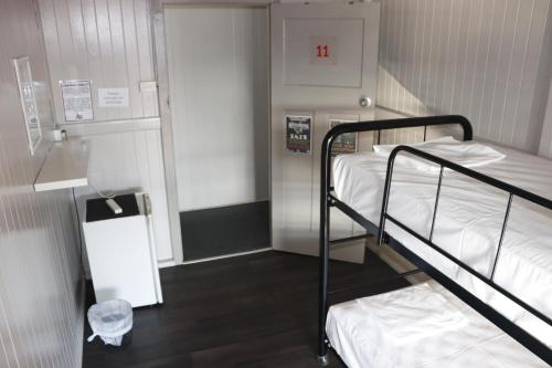 a room with two bunk beds in a hospital at The Jack Backpackers in Cairns