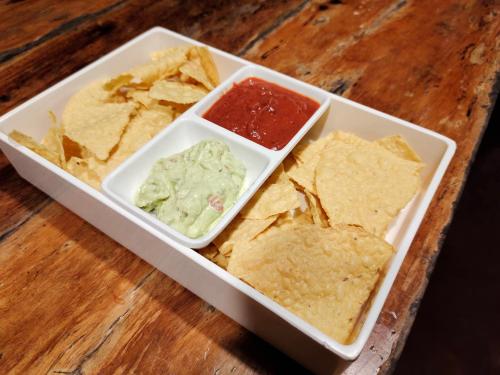 a tray with chips and guacamole and salsa at Payag n' Kapitan, Experience pinubre living in Siquijor