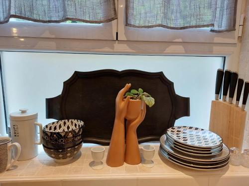 a kitchen counter with two wooden utensils and plates at Studio2 Fontaine de L'amour in Sarlat-la-Canéda