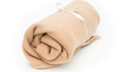 a beige blanket with a bow on a white background at Toyoko Inn Hokkaido Sapporo-eki Kita-guchi in Sapporo