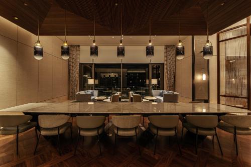 a dining room with a large table and chairs at Lotte Hotel Jeju in Seogwipo