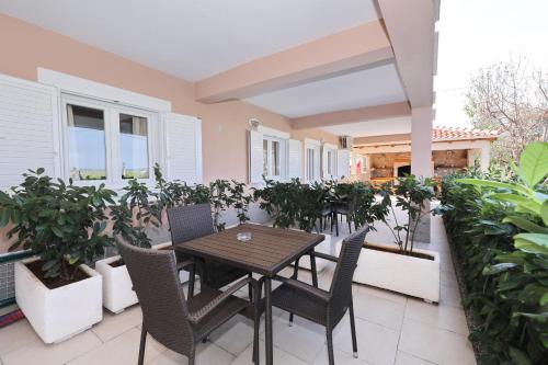 a table and chairs on a patio with plants at Apartments BoBo in Kraj