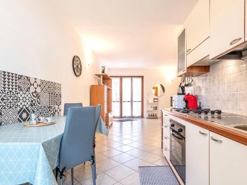 a kitchen with a table and a blue chair at A casa di Luca in Pula