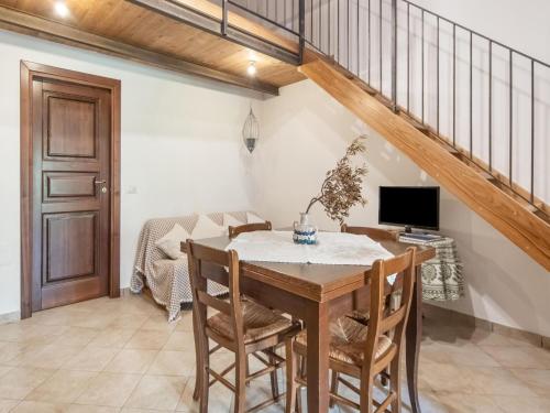 a dining room with a table and chairs and a staircase at Holiday Home in Guardavalle near River in Guardavalle