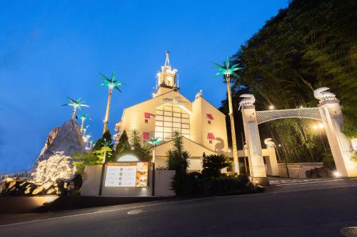 a church with palm trees on the side of a street at ホテル チャペルココナッツ 亀山 in Kameyama