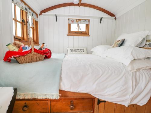 a bedroom with a large bed with baskets on it at Shepherds Hut in Lewes