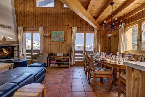 a dining room with a table and a couch at Chalet OnThePiste in La Tzoumaz