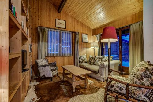 a living room with a couch and a table at Chalet Par le Travers in La Tzoumaz