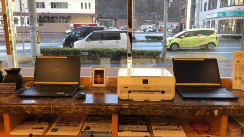 two laptops and a printer sitting on a table at Toyoko Inn Hokkaido Okhotsk Abashiri Ekimae in Abashiri