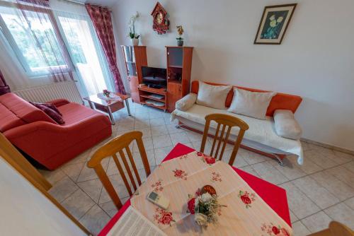 a living room with a table and a couch at Apartments Anita in Pula