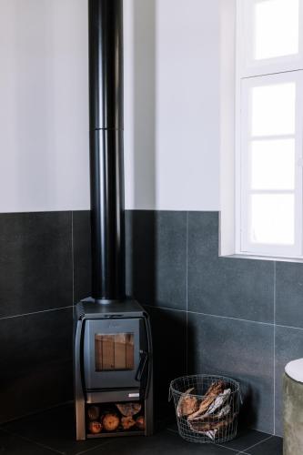 a stove in a kitchen with a basket of bread at The Benev - Wellness Accommodation in Beechworth