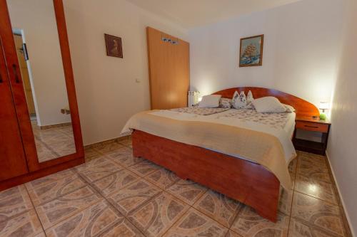 a bedroom with a large bed in a room at Apartments Anita in Pula