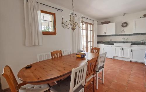 a dining room with a wooden table and chairs at Le Bariole, luxury villa with heated pool in Cesseras