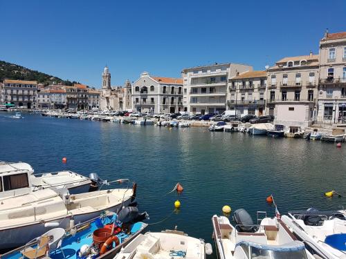 a group of boats docked in a harbor with buildings at Le Bariole, luxury villa with heated pool in Cesseras