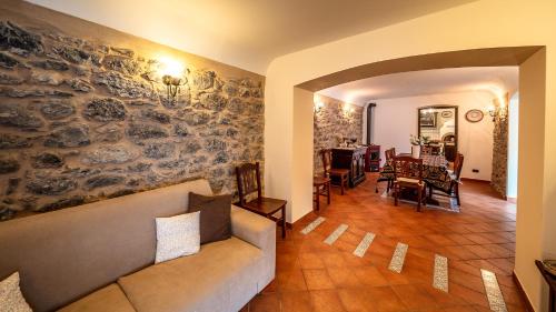 a living room with a couch and a dining room at Villa Lara in Tortorici