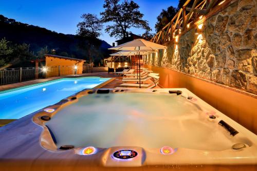 a jacuzzi tub next to a swimming pool at Villa Lara in Tortorici