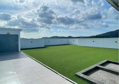 a large room with a green field of grass at Full Moon Apartment (月满公寓）网红 airbnb in Kuah