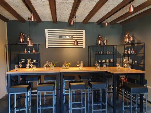 a bar with blue bar stools in a room at hb-Gästehaus in Selzach